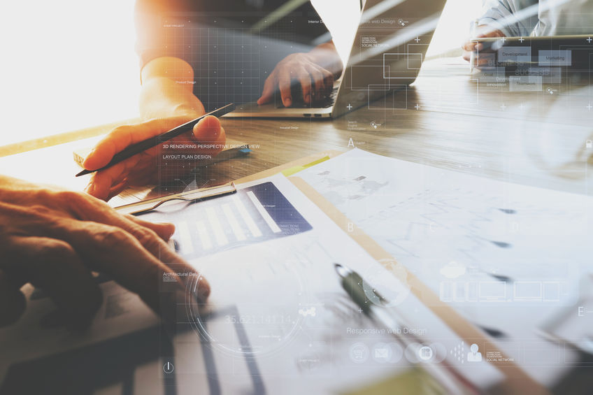three colleagues interior designer discussing data and digital tablet and computer laptop with business document and digital design diagram on wooden desk as concept